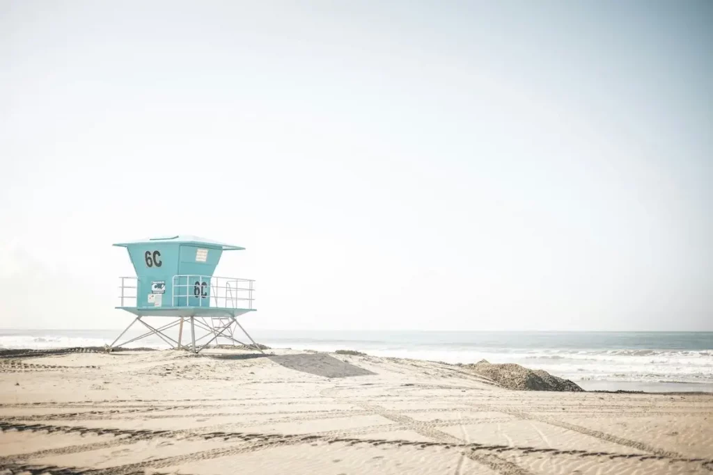 I light powder-blue lifeguard station on the beach