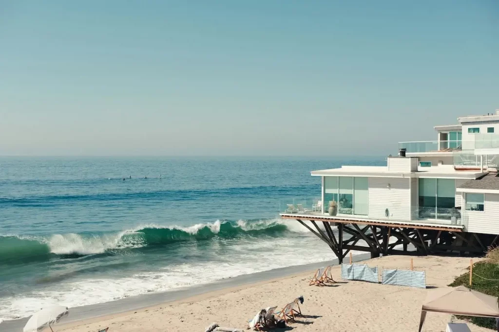 Modern beach house jutting out over the beach in Malibu